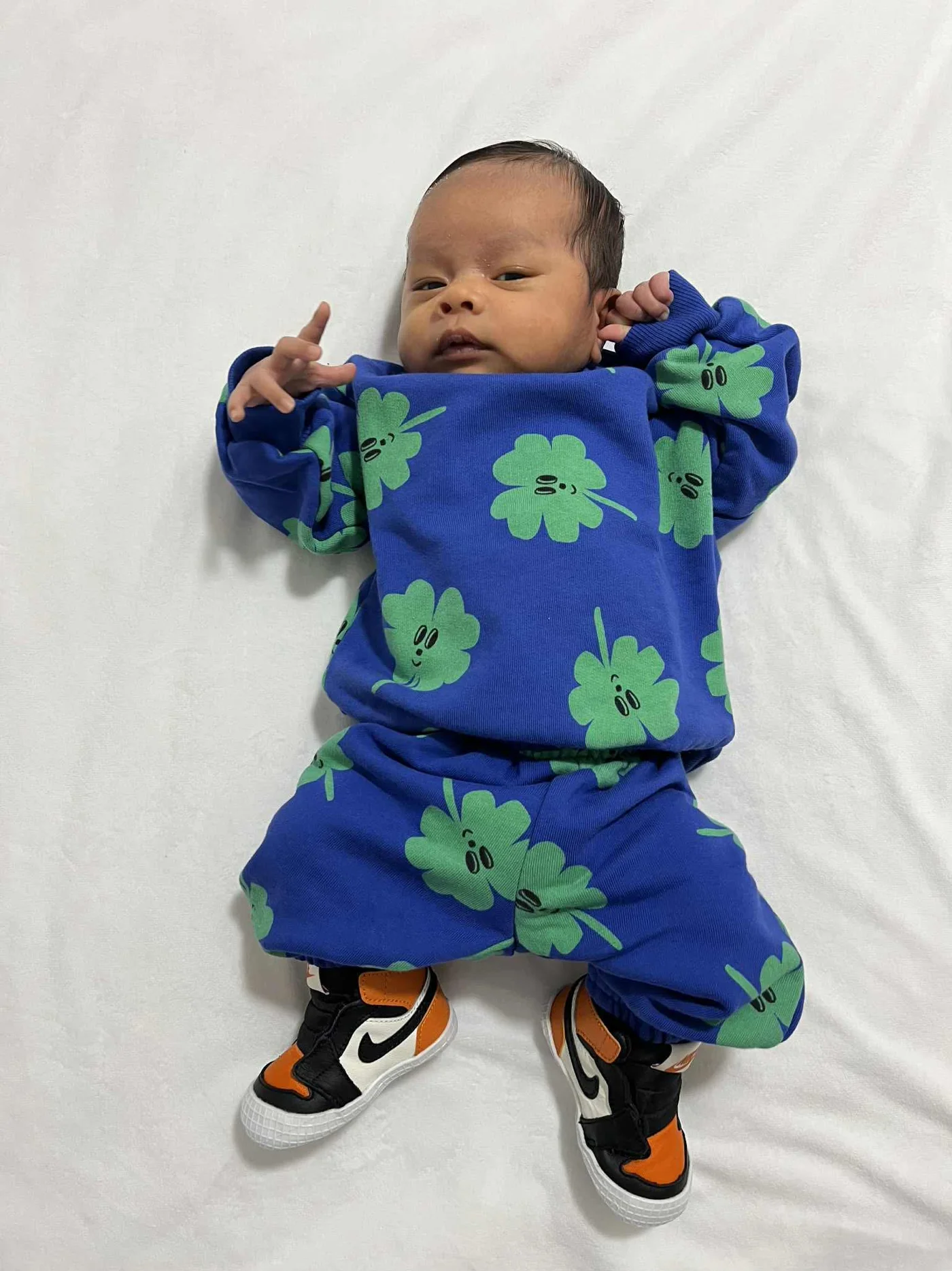Kensho resting in a green and blue outfit