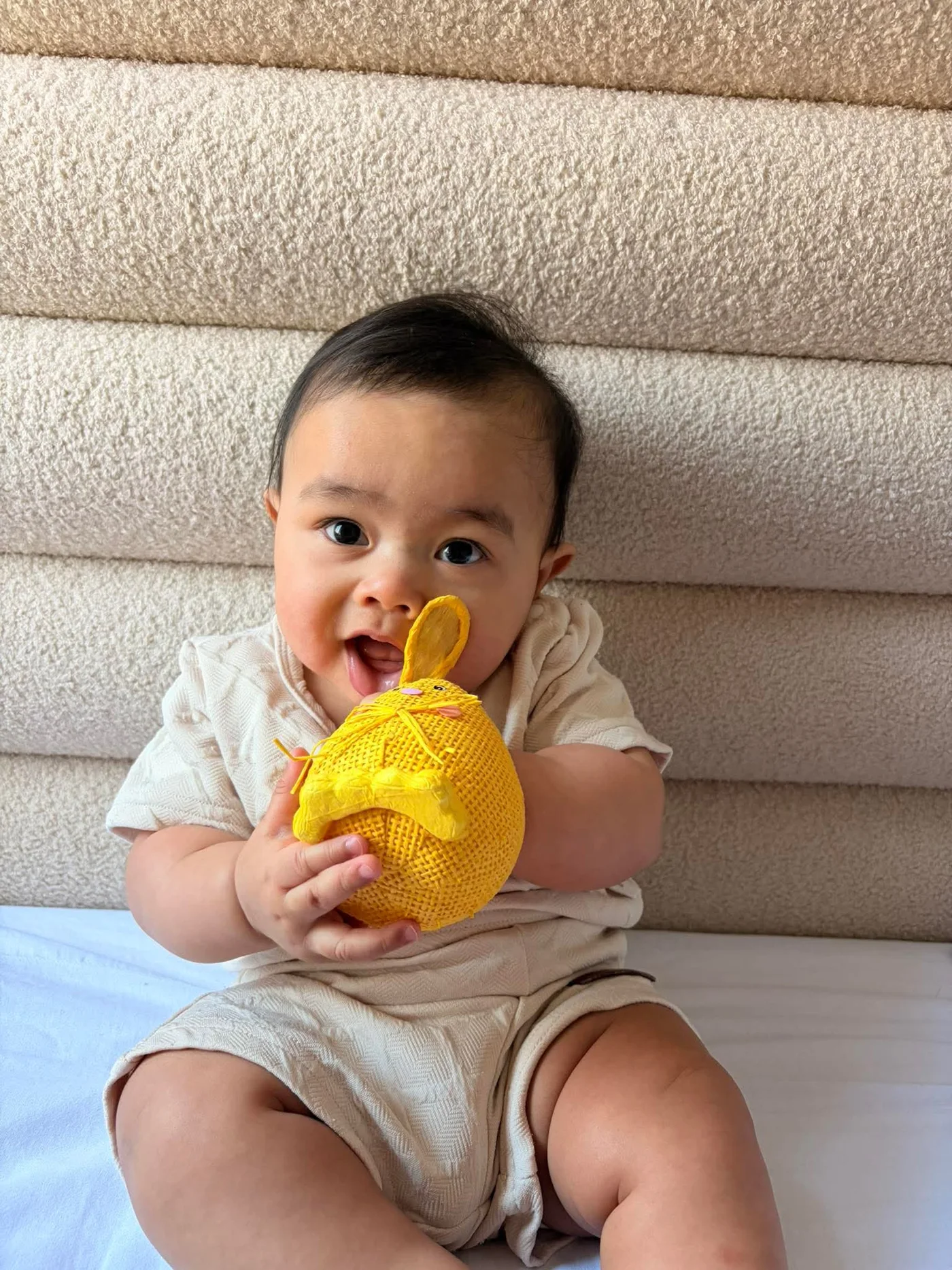 Kensho holding a bright yellow toy